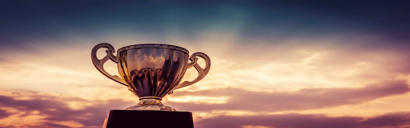 Trophy against golden sky background