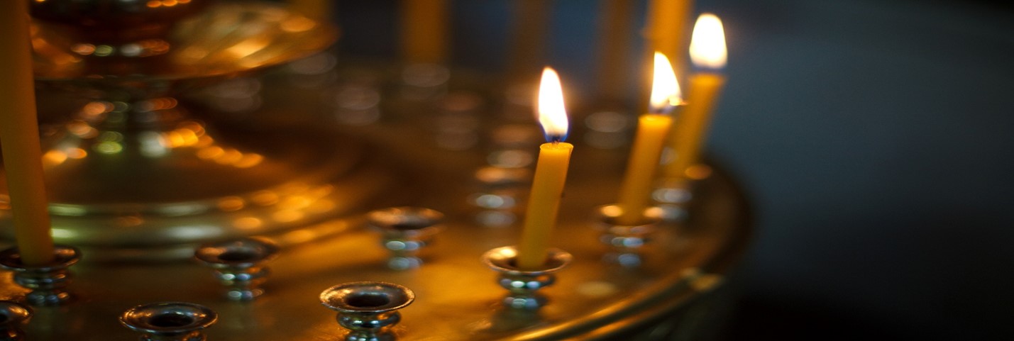 Lit candles at golden altar