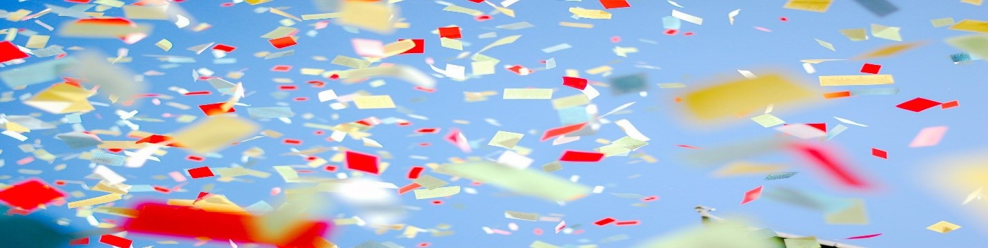 Confetti falling through the air against a blue background