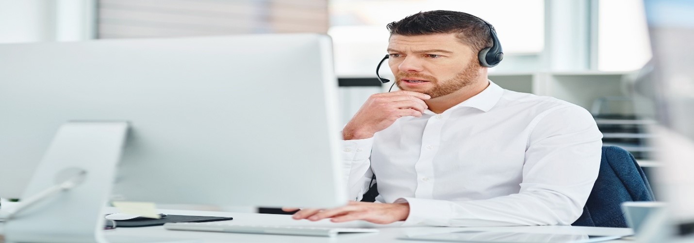 Man wearing headphones using computer