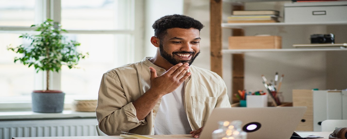 Man gesturing in front of laptop