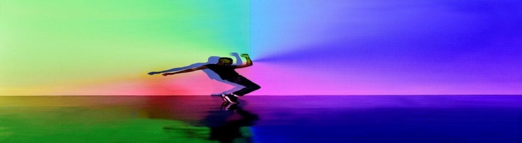 Person dancing in colorful lights