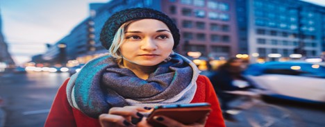 Person on street using mobile phone