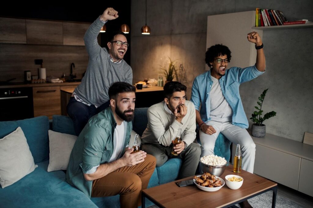 Four men watching sports