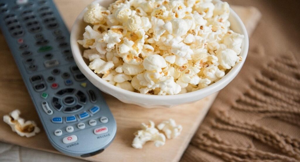 Close-up of popcorn and remote