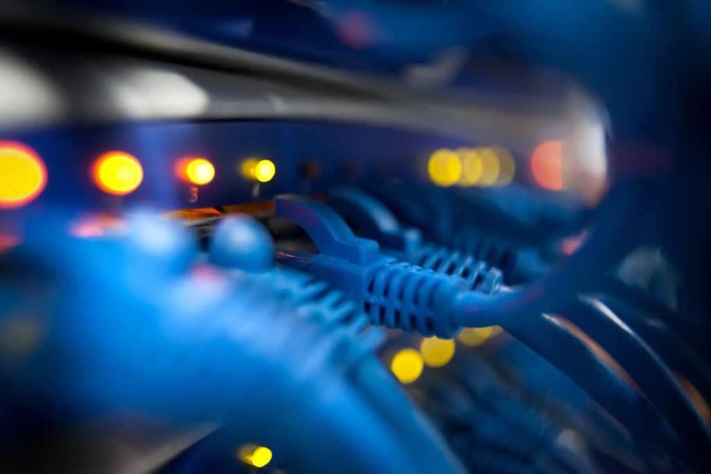 Close-up of a server network panel with lights and cables