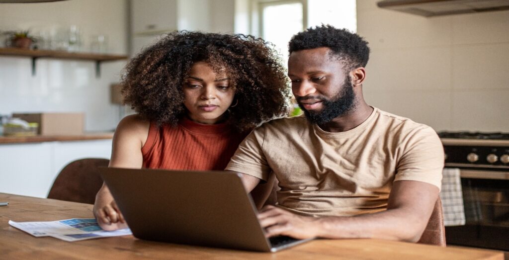 Man and woman at table with laptop